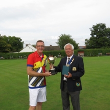 President Terry Atkinson presenting the Fours Trophy to Roy Avery Welwyn Garden City